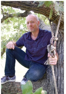 Author Image (in a tree holding a rope) 